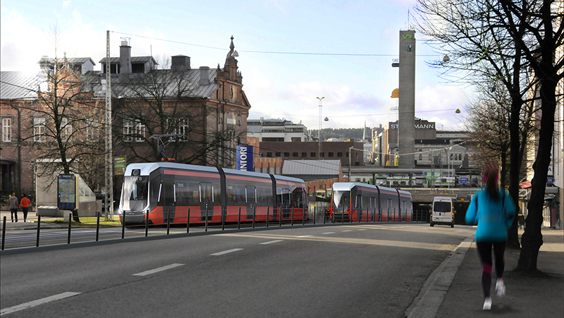 Kuvassa näkyy Tampereen punainen raitiovaunu liikenteessä kaupungin keskustassa.