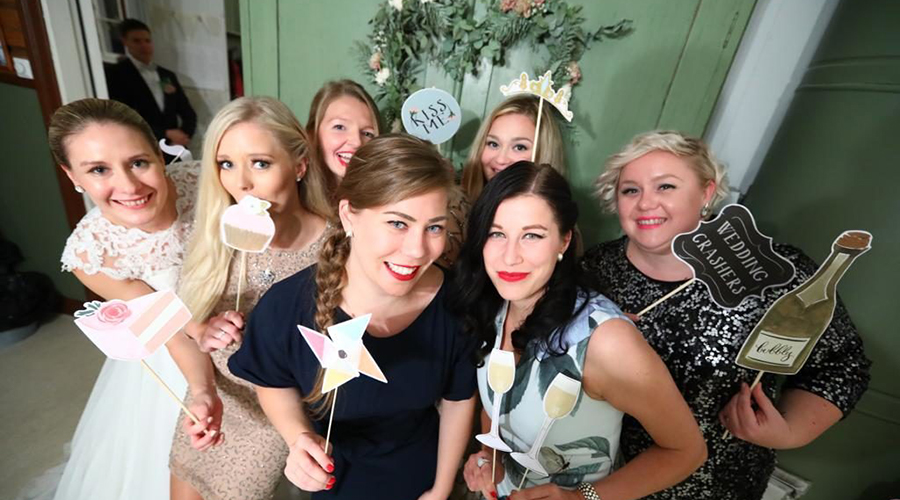 A group of smiling young women celebrating together.