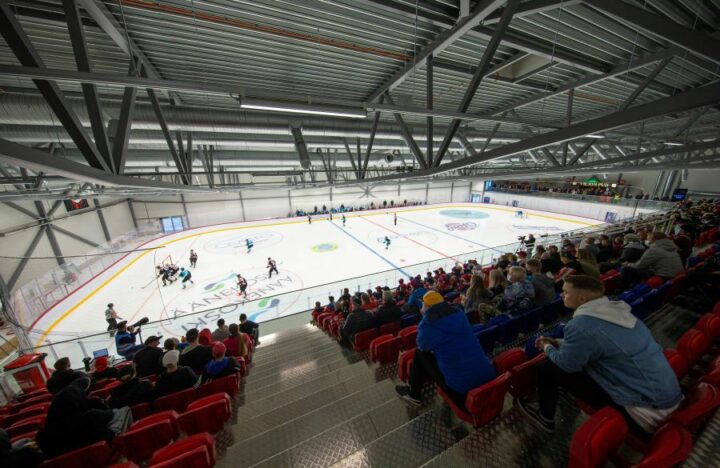 People playing ice hockey indoors at the Äänekoski ice hockey arena.