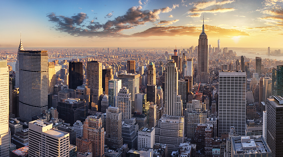 Decorative picture: Sun rising behind skyscrapers in New York City, USA.