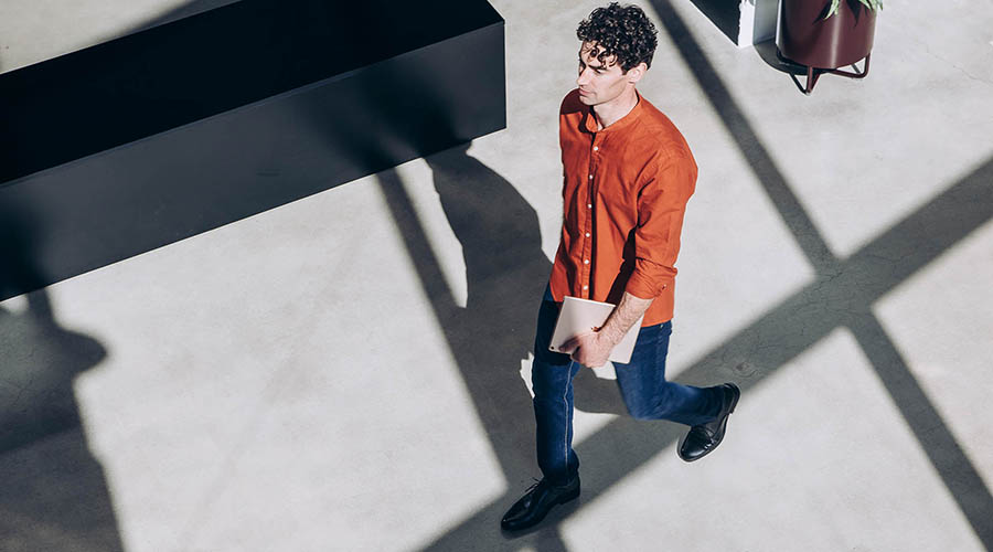 Man walking inside a building lobby