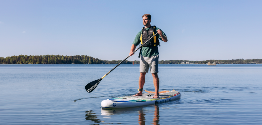 A person is sup boarding in the Finnish seaside.