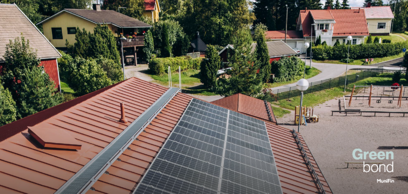 Solar panels on a red roof financed with MuniFin Green bonds.